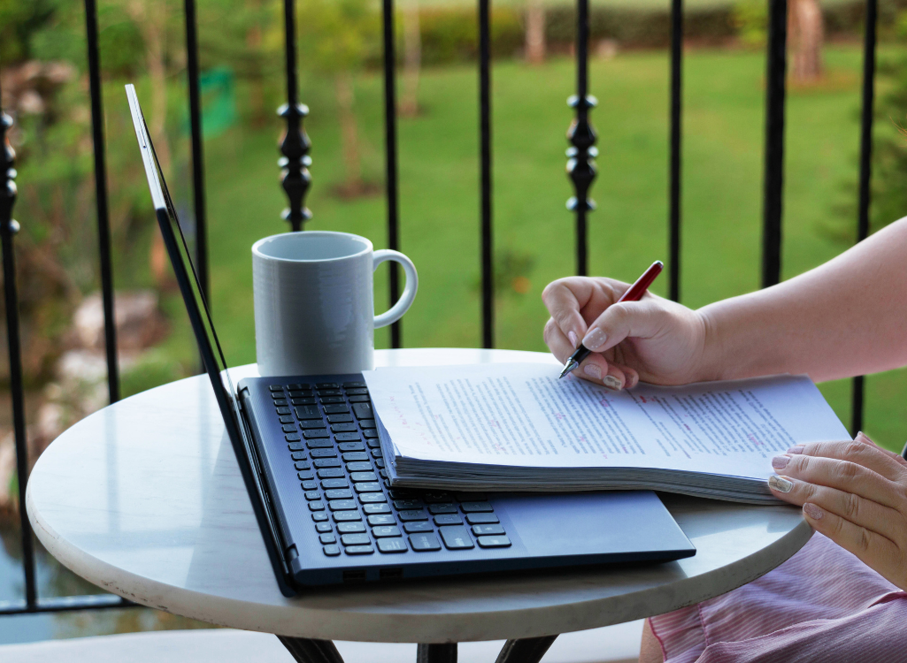 Image of person reading and editing writing to emphasise that you need to go over what you have written and proofread your content